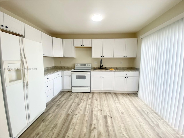 kitchen with sink, light stone counters, light hardwood / wood-style flooring, white appliances, and white cabinets