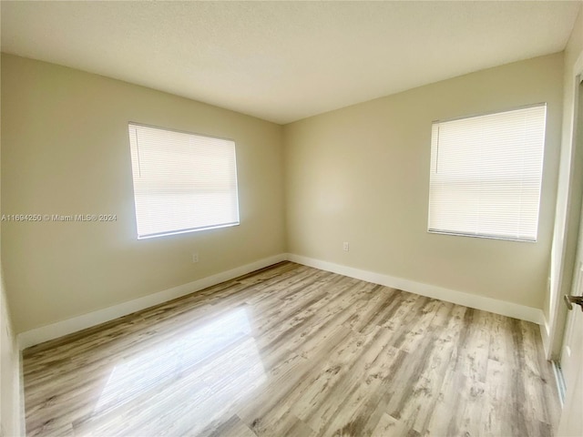 spare room with light hardwood / wood-style flooring