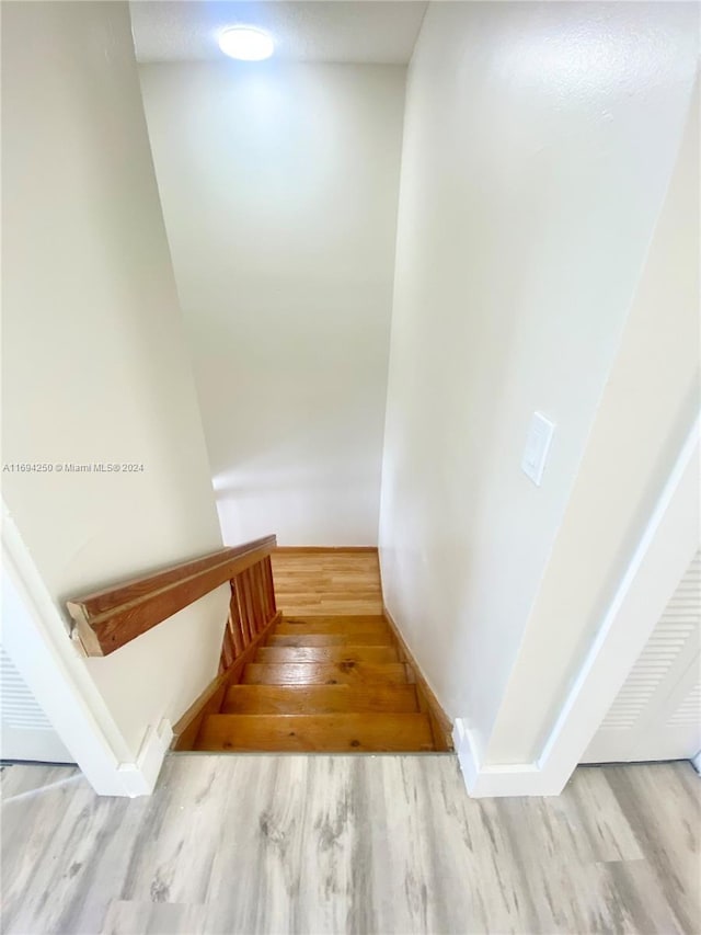 stairs featuring hardwood / wood-style flooring