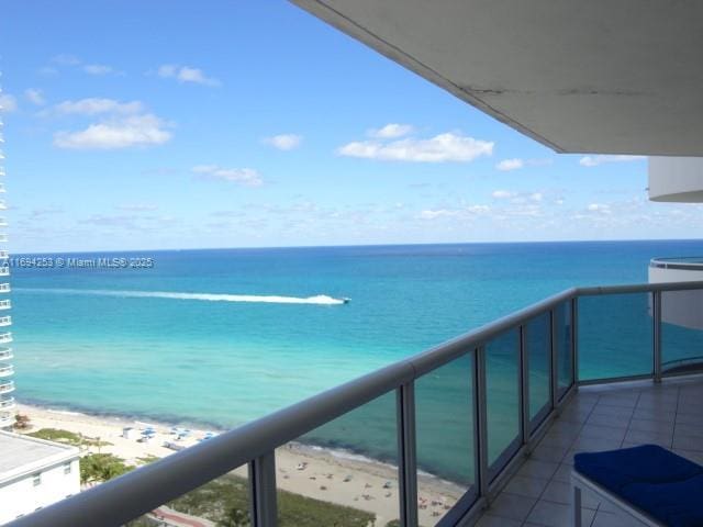 balcony with a view of the beach and a water view