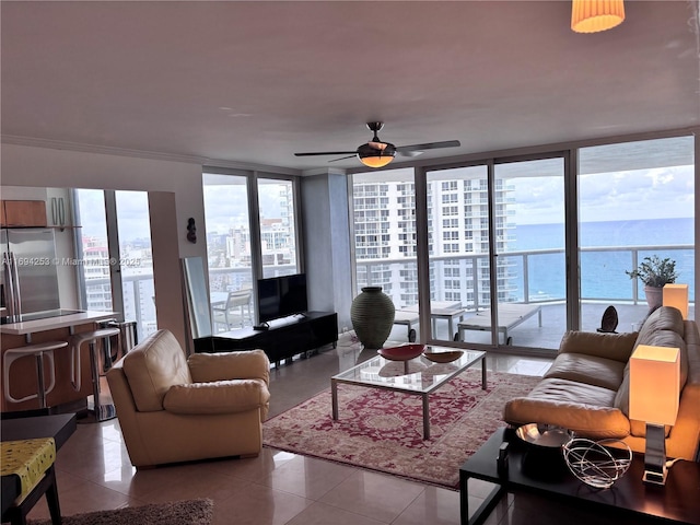 tiled living room featuring floor to ceiling windows, ornamental molding, ceiling fan, and a wealth of natural light