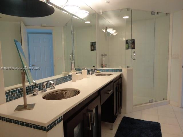 bathroom with an enclosed shower, tile patterned floors, and vanity