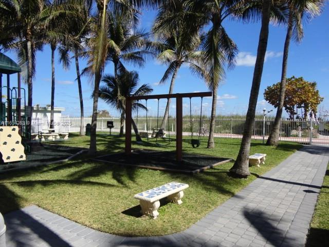 view of community featuring a lawn and a playground