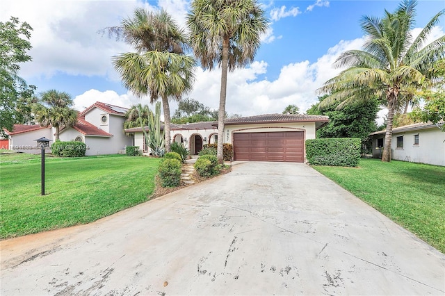 mediterranean / spanish-style home with a garage and a front yard