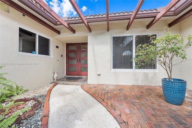 doorway to property featuring a patio area and french doors