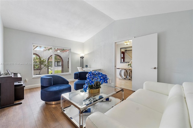 living room featuring hardwood / wood-style floors and lofted ceiling