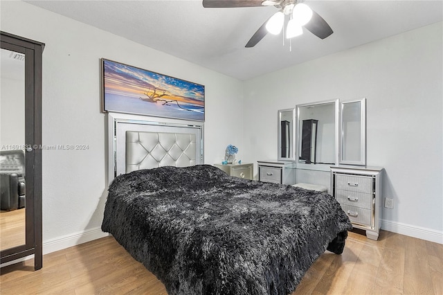 bedroom with ceiling fan and hardwood / wood-style flooring