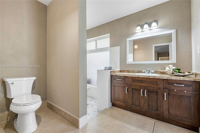 bathroom with tile patterned flooring, vanity, and toilet