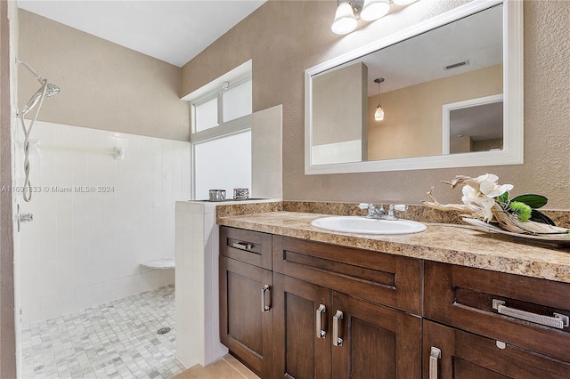 bathroom featuring vanity, tile patterned floors, and walk in shower