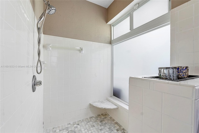 bathroom with a tile shower