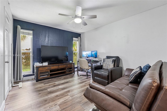 living room with a wealth of natural light, ceiling fan, and wood-type flooring