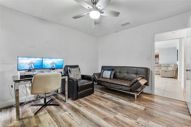 home office featuring light hardwood / wood-style floors and ceiling fan