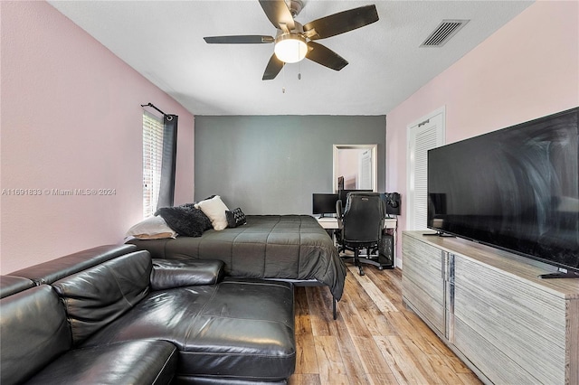 bedroom featuring ceiling fan and light hardwood / wood-style flooring