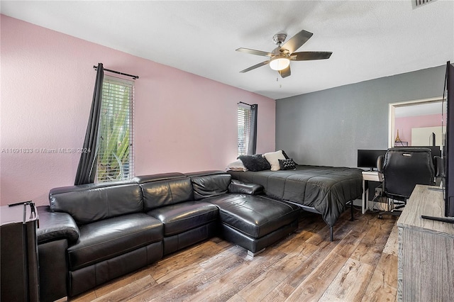 bedroom featuring light wood-type flooring and ceiling fan