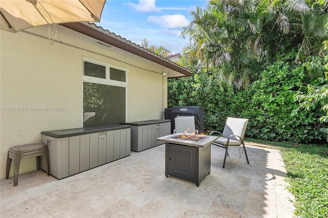 view of patio / terrace with a grill and an outdoor fire pit