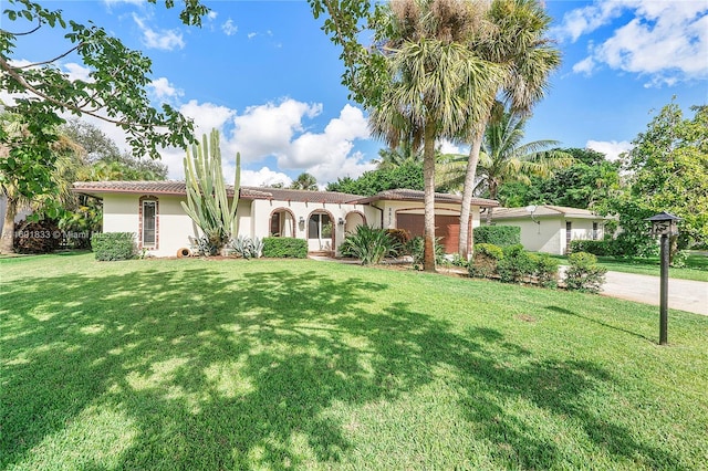 view of front of home with a garage and a front lawn