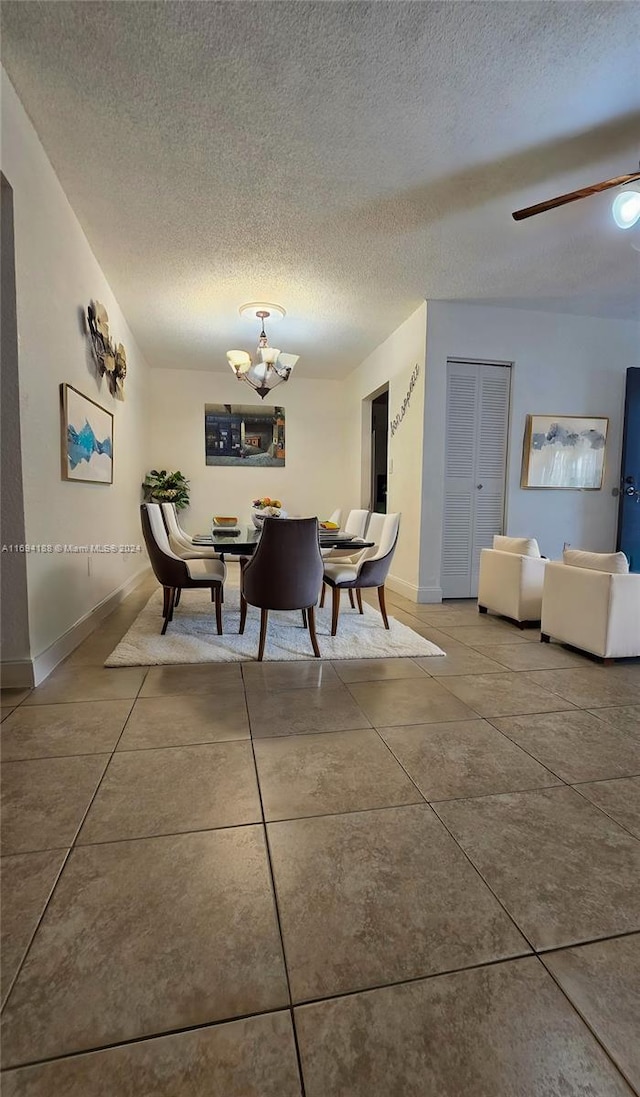 dining room with tile patterned flooring and a textured ceiling