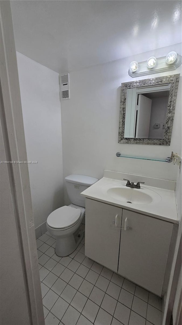 bathroom featuring tile patterned floors, vanity, and toilet