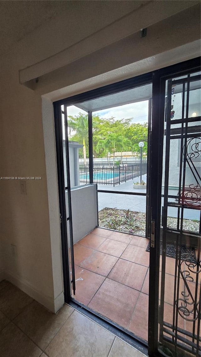 doorway to outside with tile patterned floors