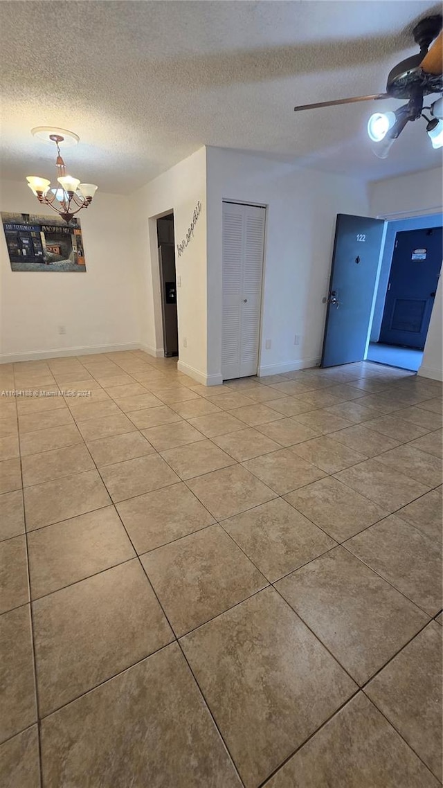 empty room with a textured ceiling and ceiling fan