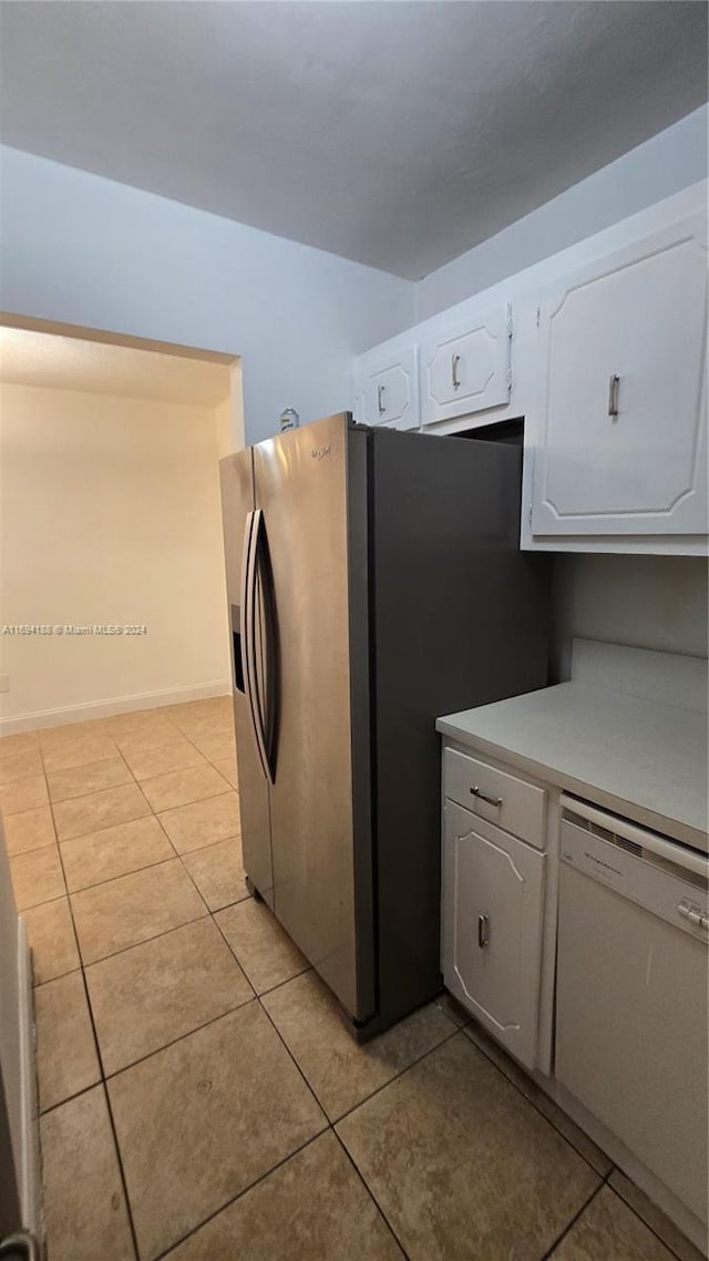 kitchen featuring white cabinetry, white dishwasher, light tile patterned flooring, and stainless steel refrigerator with ice dispenser