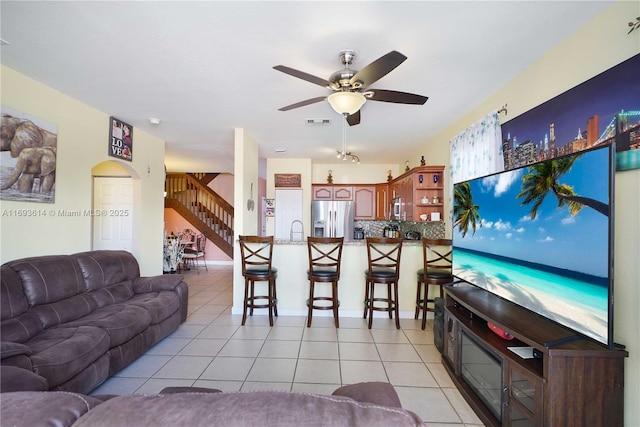 living room with sink, ceiling fan, and light tile patterned flooring