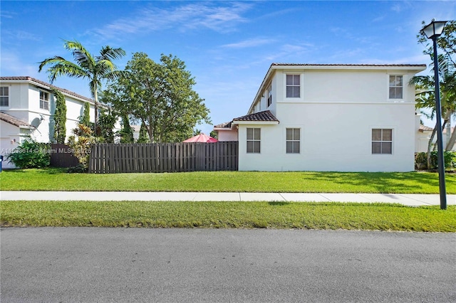 view of side of property featuring a yard