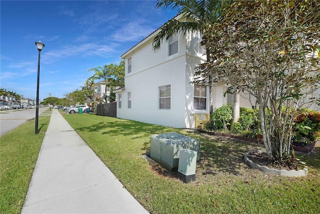 view of home's exterior with a yard