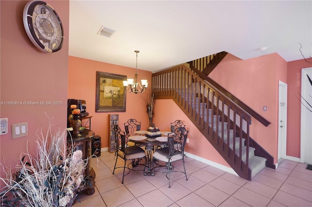 dining space with light tile patterned floors and a chandelier