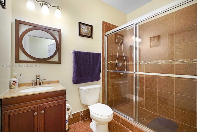 bathroom featuring tile patterned floors, vanity, toilet, and walk in shower