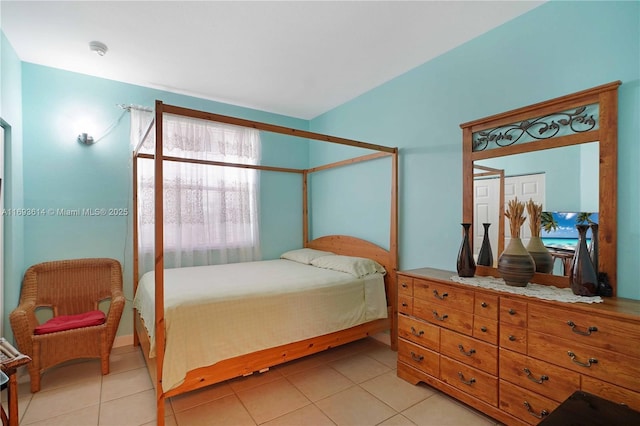 tiled bedroom with a closet