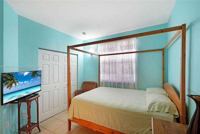 bedroom with a closet and light tile patterned flooring