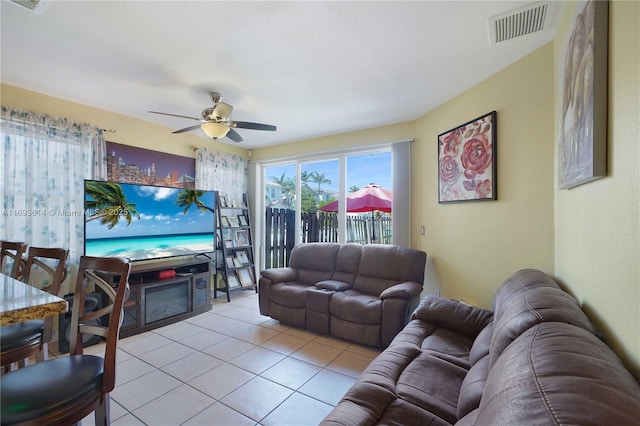 living room with ceiling fan and light tile patterned flooring