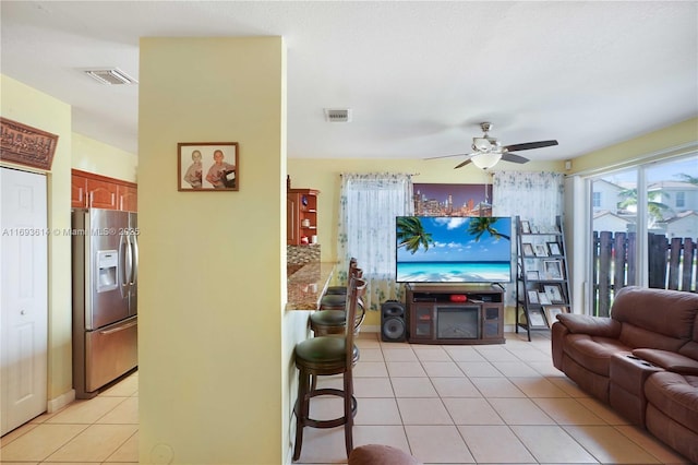 tiled living room featuring ceiling fan