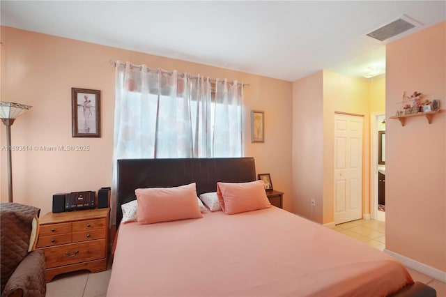 bedroom with light tile patterned floors