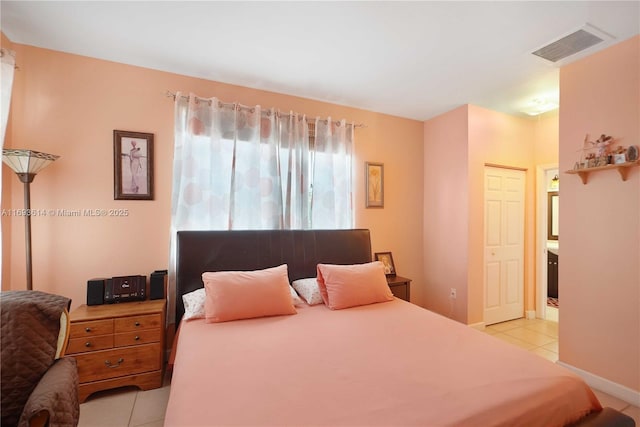 tiled bedroom with a closet