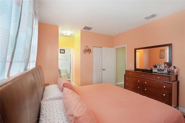 bedroom featuring ensuite bathroom and a closet