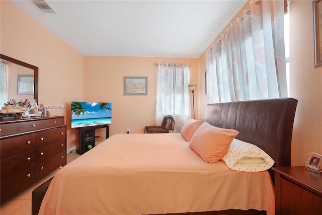 bedroom with light tile patterned floors