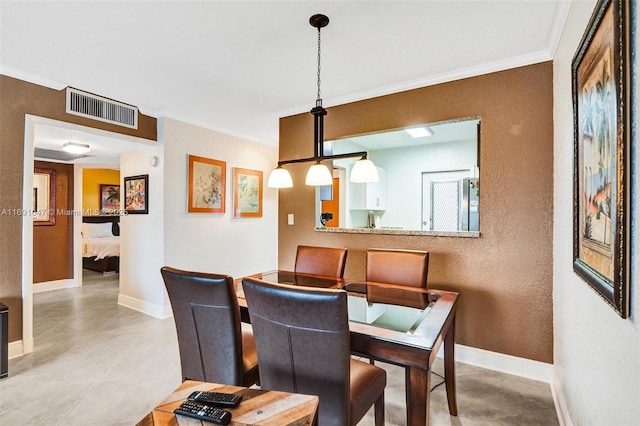 dining room featuring crown molding