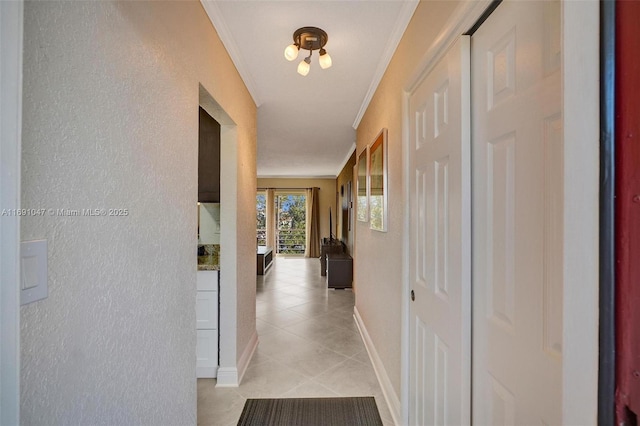 hall featuring ornamental molding and light tile patterned flooring