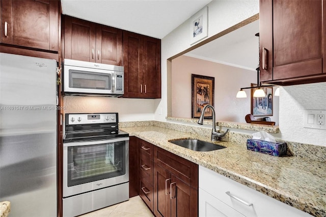 kitchen with light stone countertops, stainless steel appliances, crown molding, sink, and light tile patterned floors