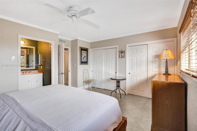 bedroom with multiple closets, ceiling fan, crown molding, ensuite bathroom, and light tile patterned floors