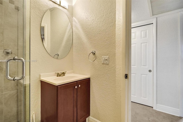 bathroom featuring vanity, tile patterned floors, and a shower with door