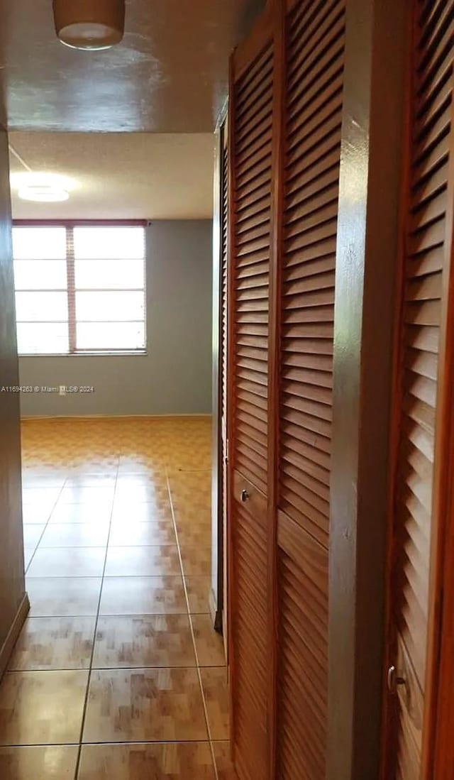 hallway with light tile patterned floors