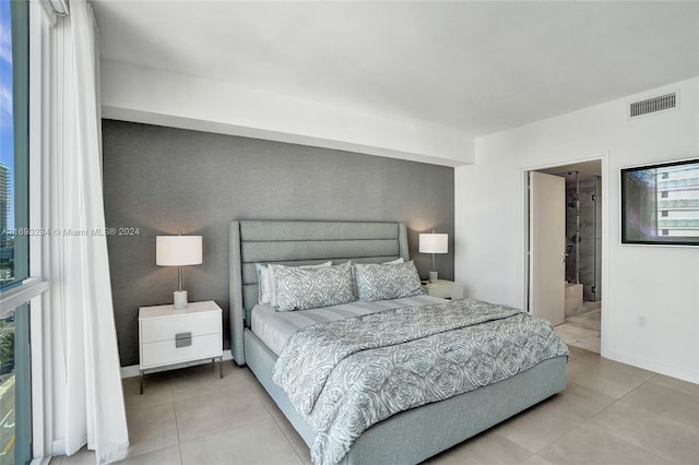 tiled bedroom featuring ensuite bath