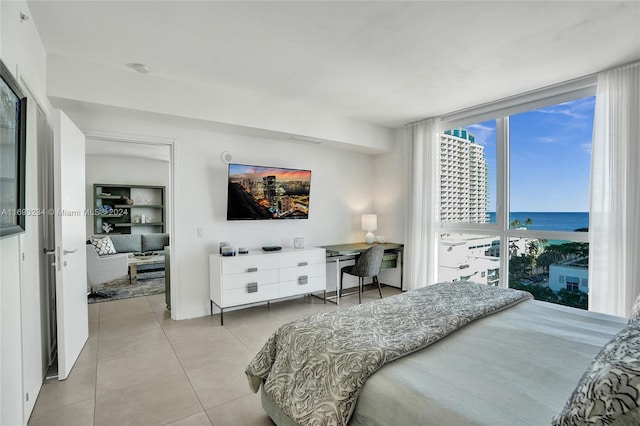 bedroom featuring light tile patterned floors and expansive windows