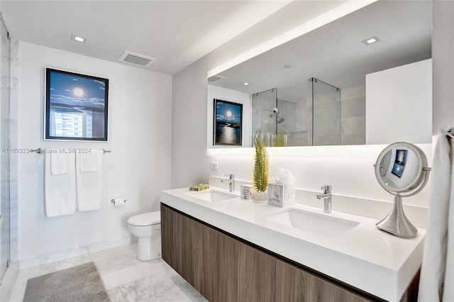 bathroom with vanity, toilet, and a shower with door