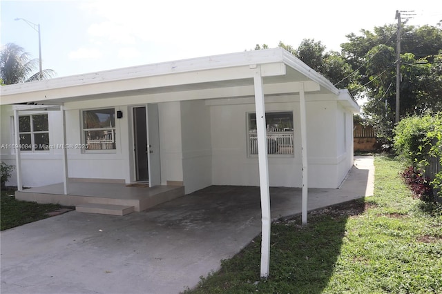 exterior space with a carport