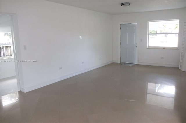 tiled empty room with a healthy amount of sunlight