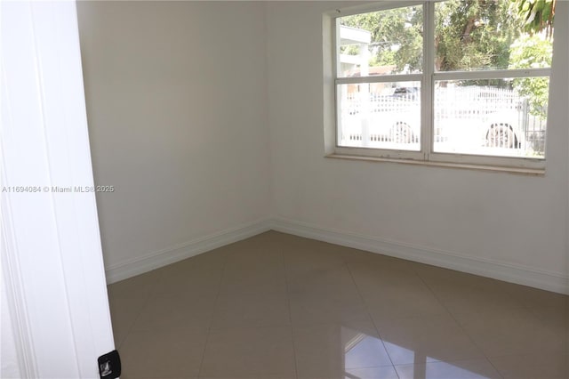 tiled empty room with a wealth of natural light